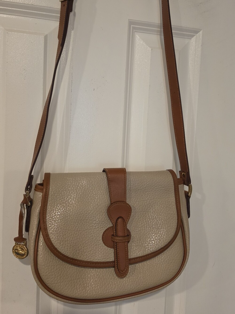 Dooney & Bourke Cream Pebbled Leather Saddle Crossbody with Tan Trim